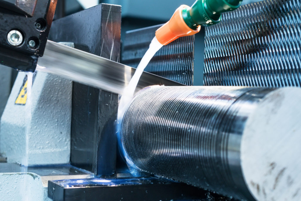Automatic bandsaw sawing metal workpiece.